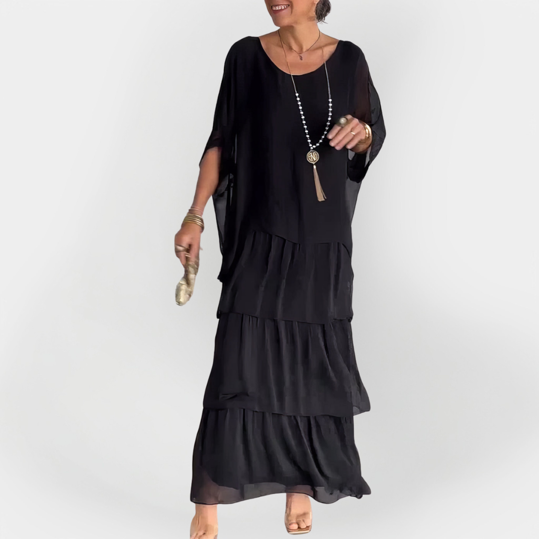 Plisirana obleka z dvojnim slojem" can be rewritten as "Dvojnoslojna plisirana obleka.